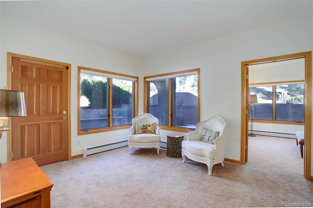 sitting room with baseboard heating and light colored carpet