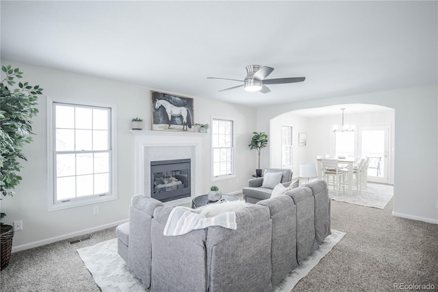 carpeted living room with ceiling fan