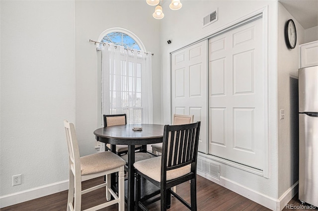 dining space with visible vents, baseboards, and dark wood-type flooring