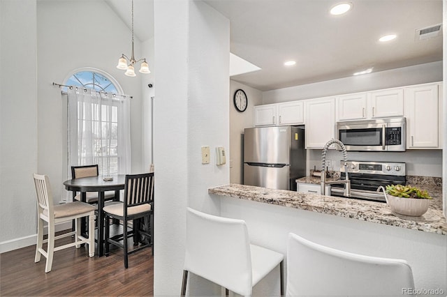 kitchen with appliances with stainless steel finishes, dark wood-style flooring, visible vents, and white cabinetry