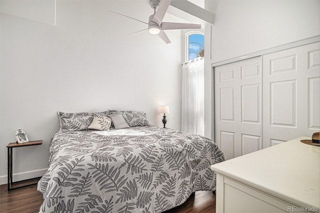 bedroom featuring a closet, dark wood-style flooring, and baseboards