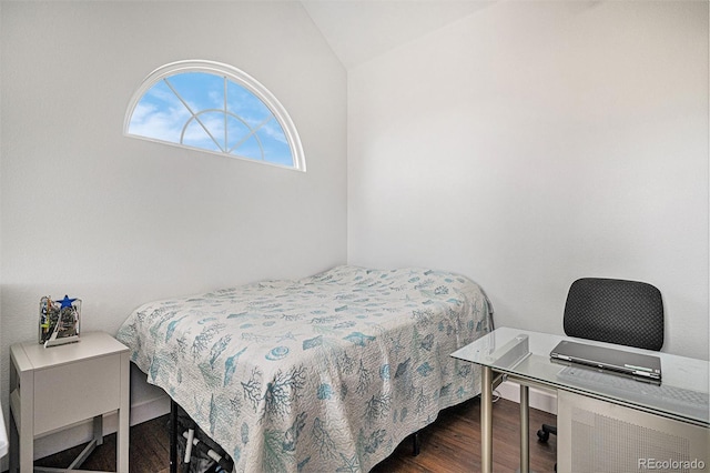 bedroom with lofted ceiling and wood finished floors