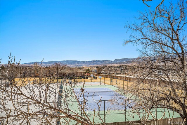 view of water feature with fence and a mountain view