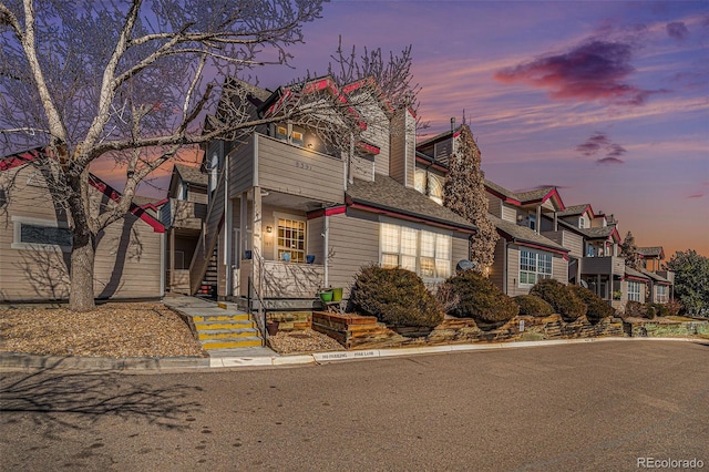 view of front of house with a residential view and a balcony