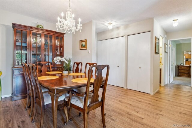 dining space featuring a chandelier and light hardwood / wood-style flooring