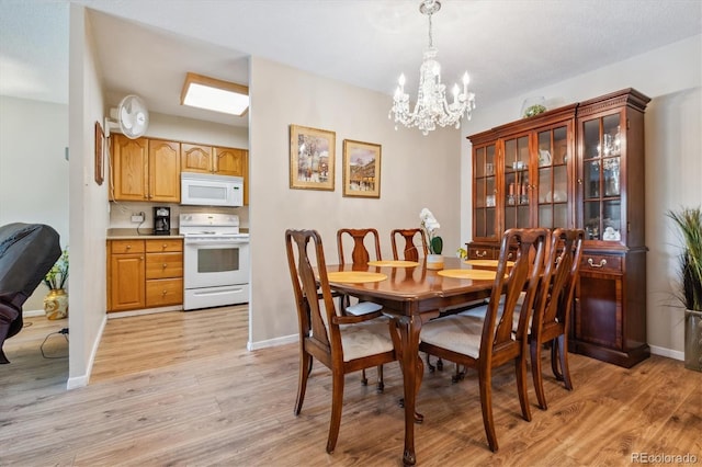 dining room featuring light hardwood / wood-style floors and a chandelier