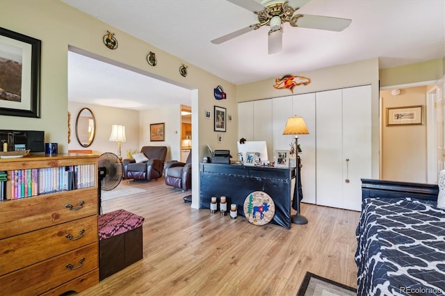 bedroom with ceiling fan, a closet, and light wood-type flooring