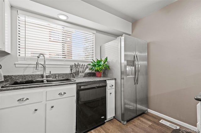 kitchen with stainless steel refrigerator with ice dispenser, sink, white cabinetry, dark hardwood / wood-style flooring, and dishwasher