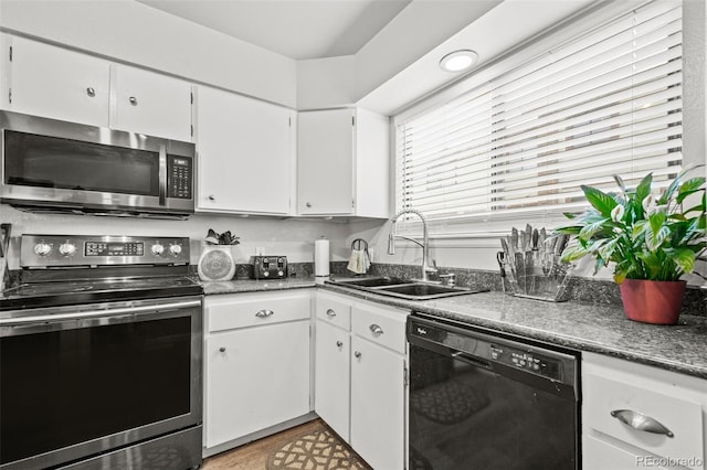 kitchen featuring white cabinetry, stainless steel appliances, and sink