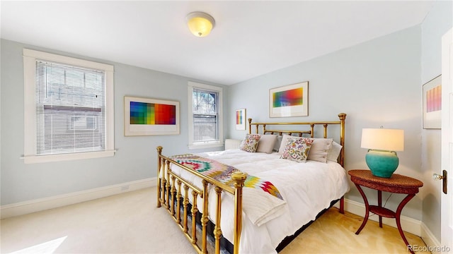 carpeted bedroom featuring baseboards