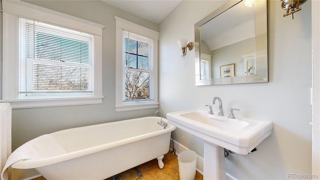 full bath with a freestanding tub and tile patterned floors