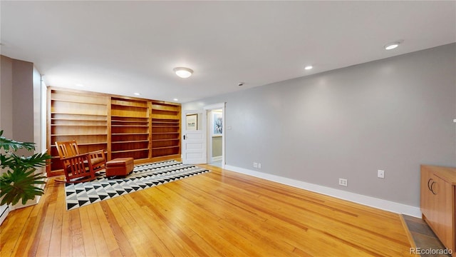 unfurnished room with recessed lighting, baseboards, and hardwood / wood-style floors