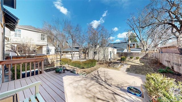 wooden terrace with an outbuilding, a fenced backyard, and a residential view