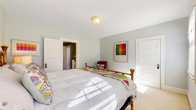 carpeted bedroom featuring baseboards