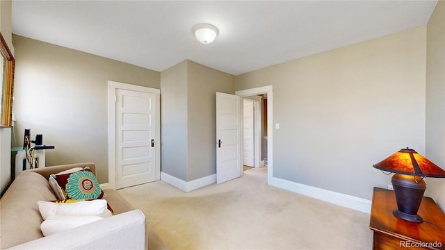 sitting room with light carpet and baseboards