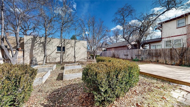 view of yard with a garden and fence