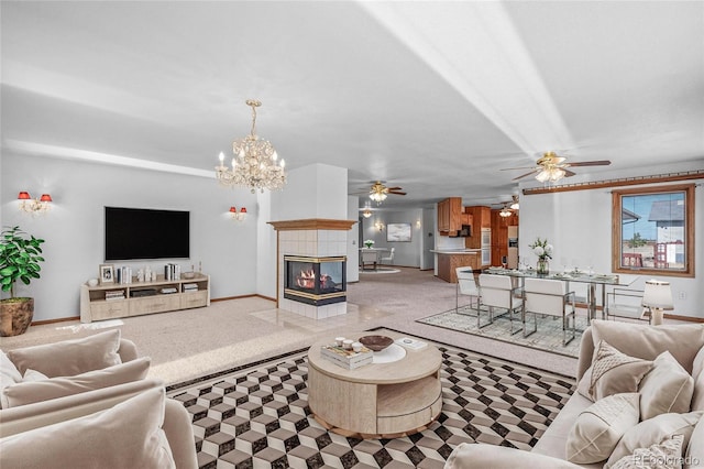 living room with a notable chandelier, carpet flooring, and a fireplace