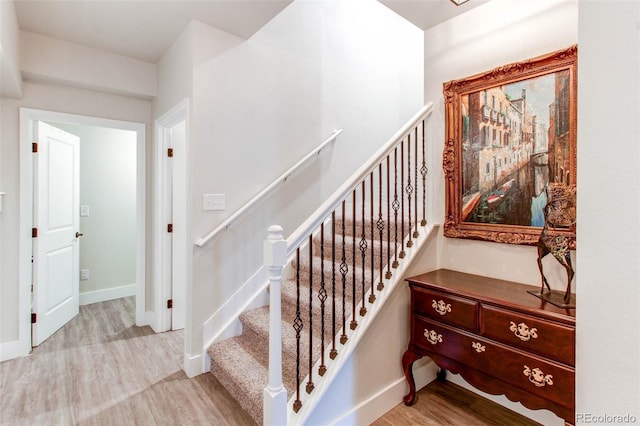 stairs with hardwood / wood-style floors