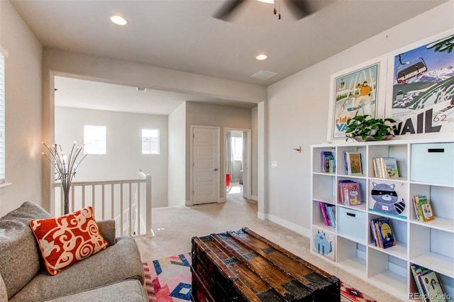 carpeted living room featuring ceiling fan