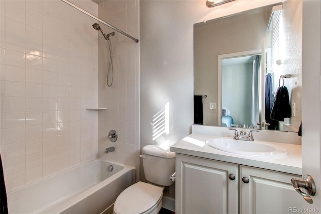 full bathroom featuring toilet, vanity, and tiled shower / bath