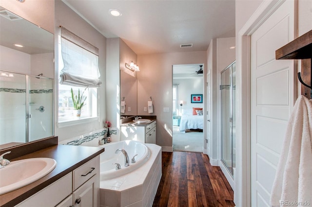 bathroom with wood-type flooring, ceiling fan, independent shower and bath, and vanity