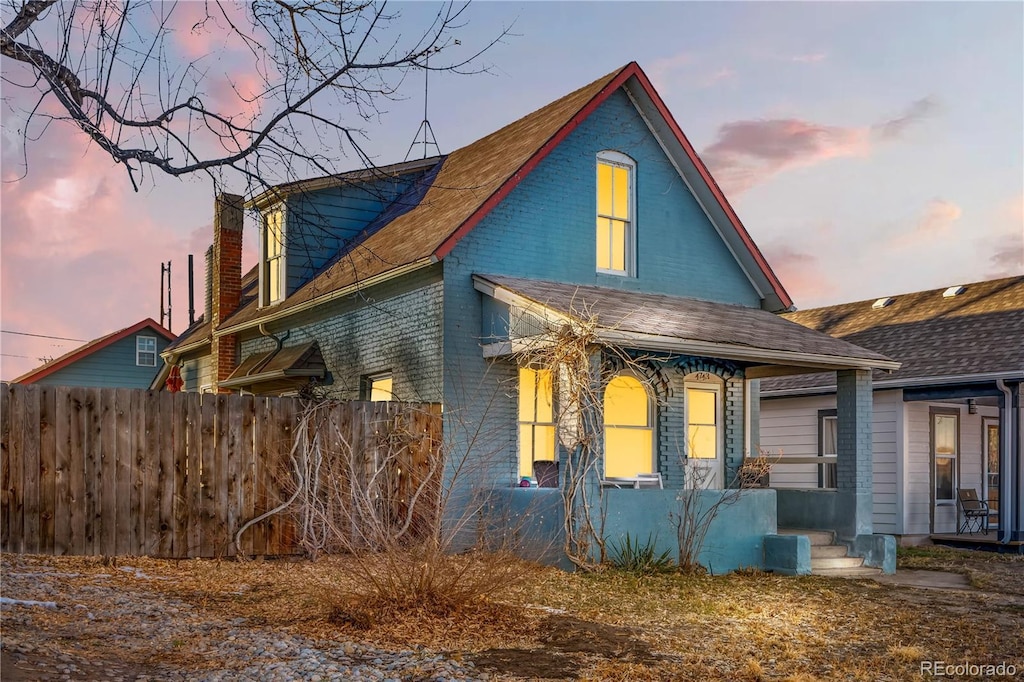 property exterior at dusk with covered porch