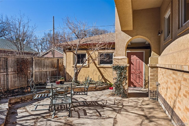 view of patio / terrace with outdoor dining space and fence