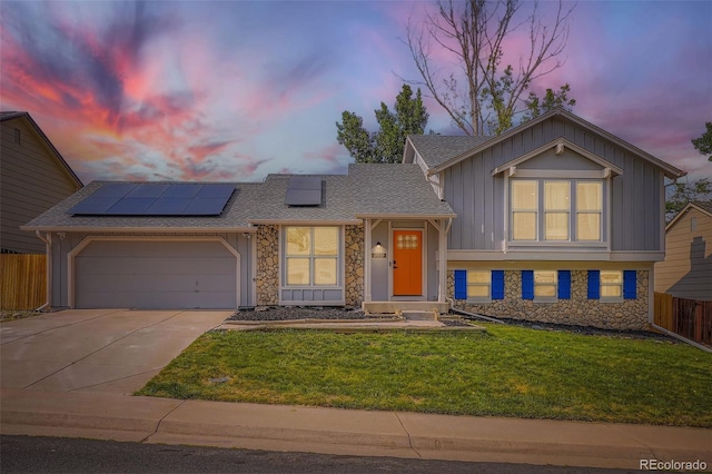 19859 E Prentice Pl, Centennial, CO 80015 - tri-level home with stone siding, board and batten siding, driveway, and roof mounted solar panels