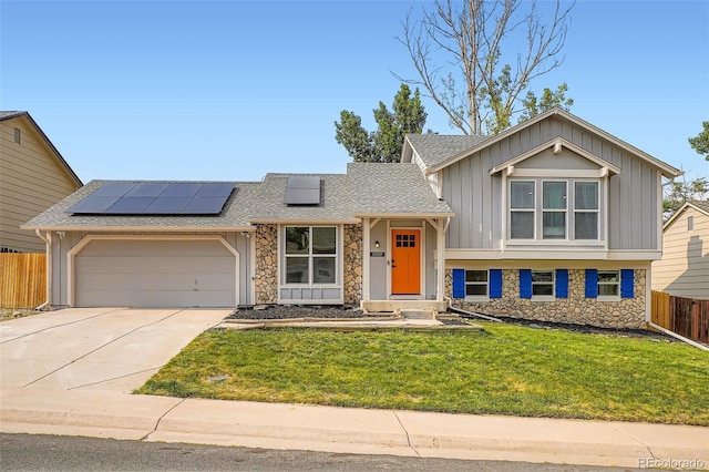 19859 E Prentice Pl, Centennial, CO 80015 - tri-level home with stone siding, board and batten siding, solar panels, and concrete driveway