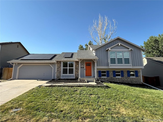 19859 E Prentice Pl, Centennial, CO 80015 - split level home with stone siding, solar panels, concrete driveway, an attached garage, and board and batten siding