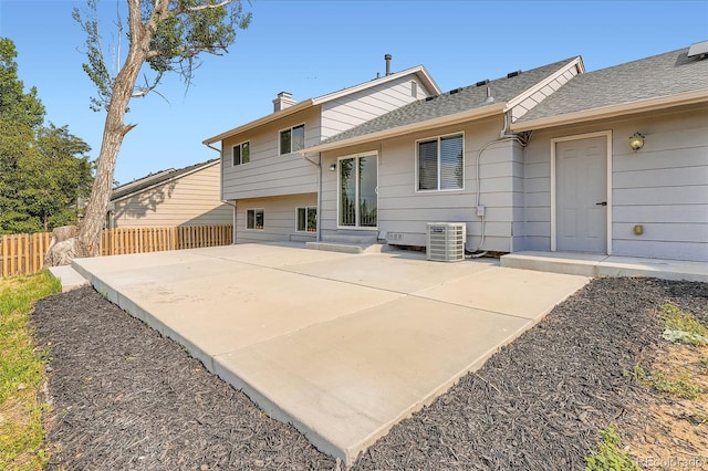 19859 E Prentice Pl, Centennial, CO 80015 - rear view of house with a patio area, a chimney, and roof with shingles