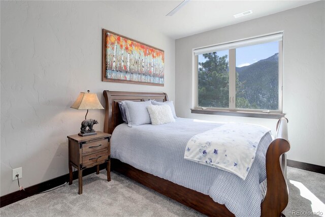 carpeted bedroom with baseboards and visible vents