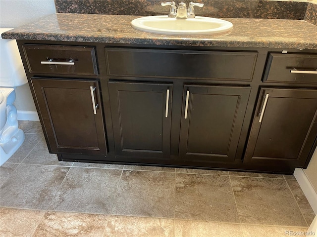 bathroom featuring a sink and baseboards