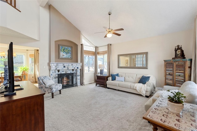 carpeted living room featuring baseboards, a ceiling fan, high vaulted ceiling, and a tile fireplace