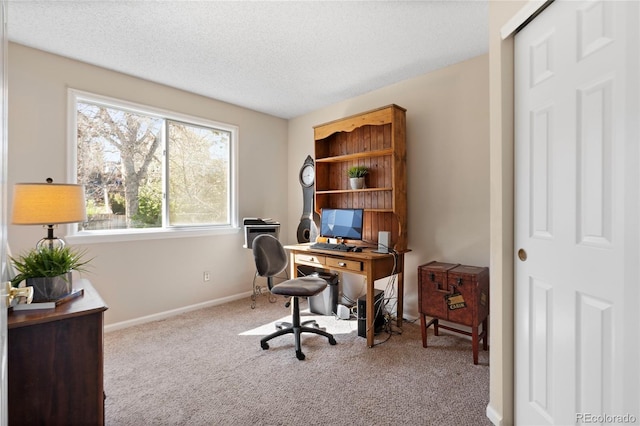 home office with carpet floors, baseboards, a textured ceiling, and a wealth of natural light