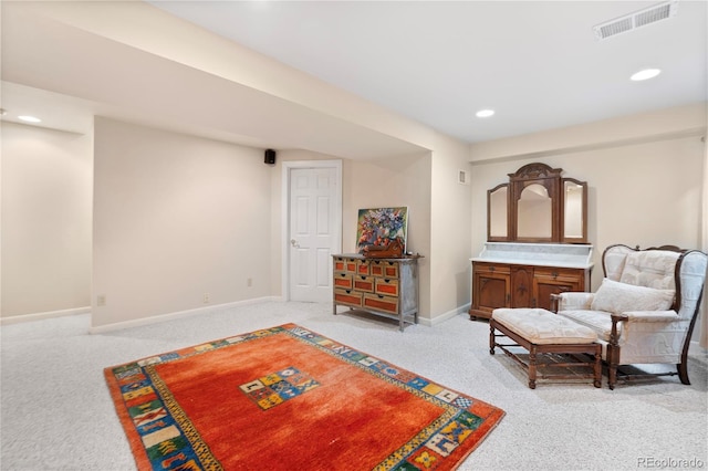 sitting room with recessed lighting, baseboards, light colored carpet, and visible vents
