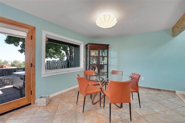 dining area with beam ceiling