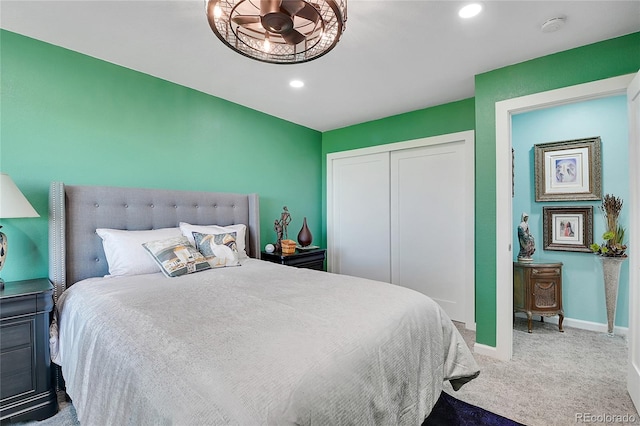 carpeted bedroom with a closet and ceiling fan