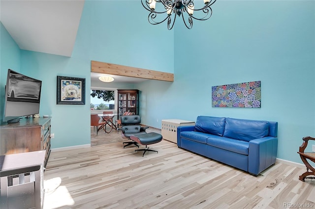 living room with light hardwood / wood-style floors and a chandelier