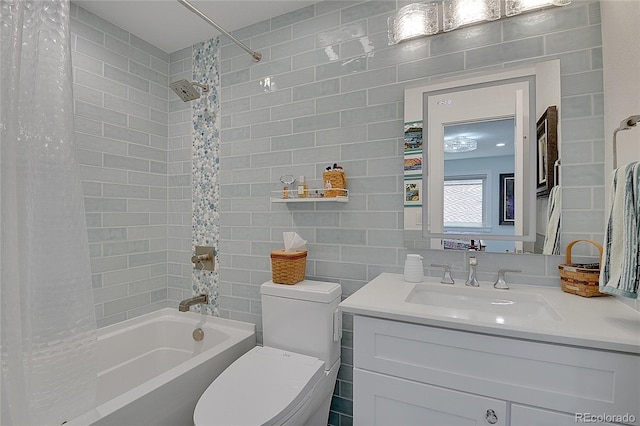 full bathroom featuring shower / bath combination with curtain, vanity, tile walls, and toilet