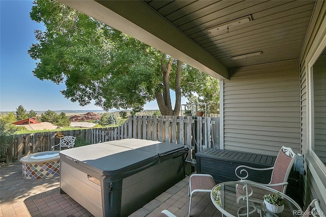 wooden terrace with a patio and a hot tub