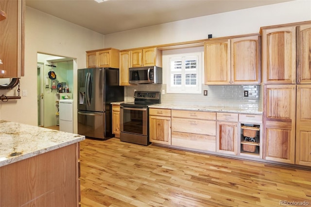 523 Pulver Rd, Lake George, CO 80827 - kitchen with stainless steel appliances, light wood-style floors, backsplash, and washer / clothes dryer