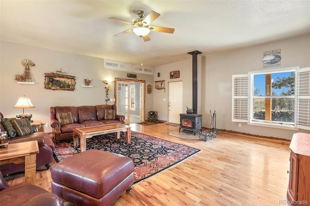 523 Pulver Rd, Lake George, CO 80827 - living room with wood finished floors, a wood stove, ceiling fan, and healthy amount of natural light