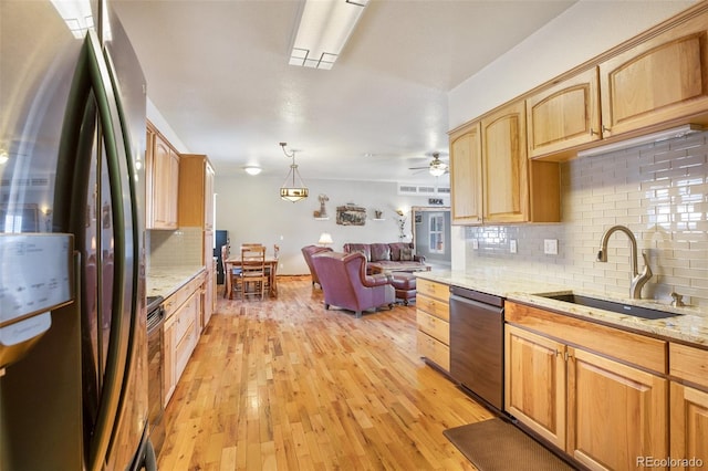 523 Pulver Rd, Lake George, CO 80827 - kitchen with appliances with stainless steel finishes, open floor plan, tasteful backsplash, light stone counters, and light wood-style floors