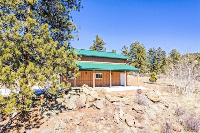 523 Pulver Rd, Lake George, CO 80827 - view of front of house with board and batten siding, a metal roof, and an outdoor structure