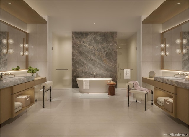 185 Steele St Unit 408, Denver, CO 80206 - bathroom featuring tile walls, a freestanding bath, vanity, and tile patterned flooring