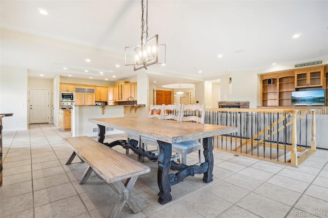 tiled dining space featuring a notable chandelier