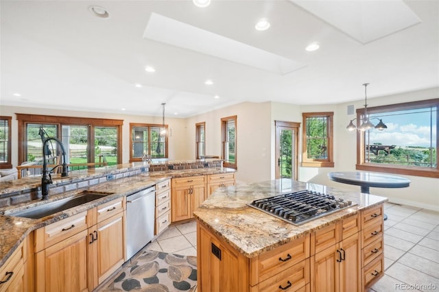 kitchen featuring a kitchen island, decorative light fixtures, appliances with stainless steel finishes, sink, and light tile patterned flooring