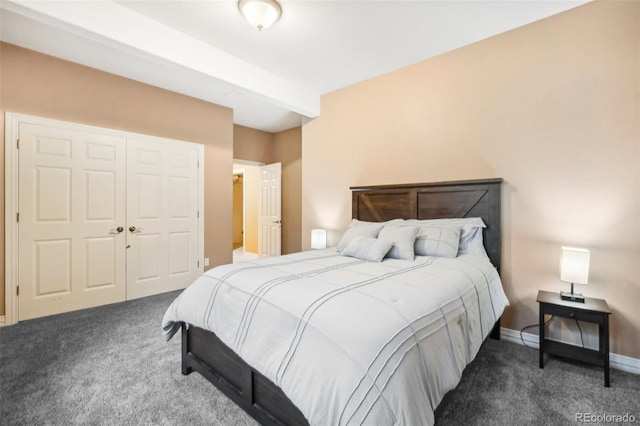 bedroom featuring dark carpet and a closet