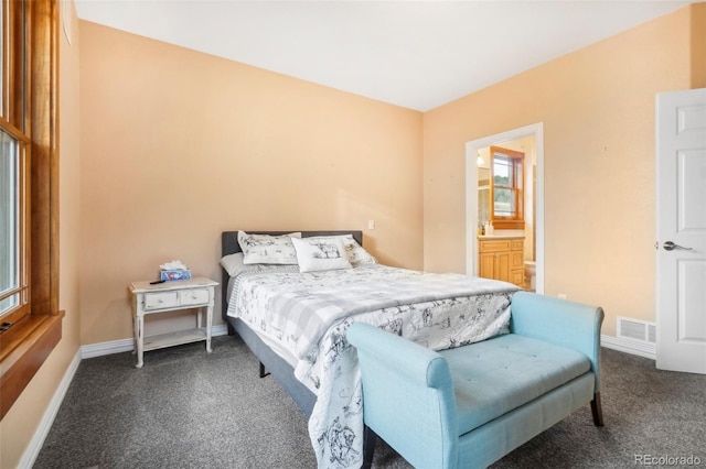 carpeted bedroom featuring connected bathroom